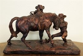 Vintage ceramic sculpture by Joe Back of Dubois,Wyoming. Two cowboys breaking a horse; one is biting the horse's ear. Measures 16 1/2" long x 8 1/2" wide x 11" tall