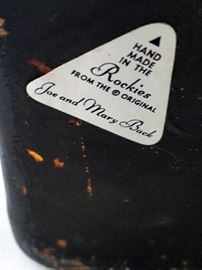 Vintage ceramic sculpture by Joe Back of Dubois,Wyoming. Two cowboys breaking a horse; one is biting the horse's ear. Measures 16 1/2" long x 8 1/2" wide x 11" tall