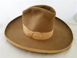 Grosgrain ribbon band and brim edge. Has a great early photo of a cowgirl printed inside the liner. Size 7 1/4. Thought this was an early Stetson when I saw it, but I don't recognize the trademark. Bet you experts do! Hat is in good condition. Has some spots here and there,
