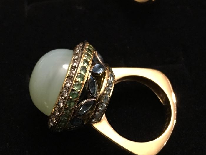 18K gold ring - the main stone is Chalcedony quartz and it surrounded by Diamonds along with Garnets and Aquaramines and Blue Zircon - the ring is a size 7
