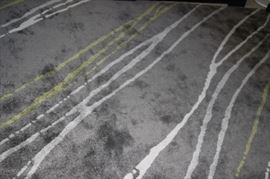 Grey, white and yellow striped area rug.