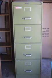 Four drawer metal filing cabinet.