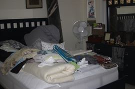 Full size bed, blankets, comforters, linens, fan, area rug.