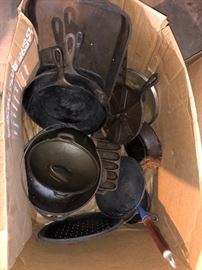 A boxful of cast iron pots and pans
