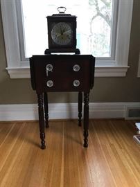 Two drawer mahogany drop leaf stand with turned legs.  Contemporary "Trend" clock.