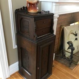 Unusual cabinet.  Two drawers over door with shelves.  Picture doesn't due this piece justice.  Original surface.