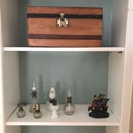 Top shelf is great child's trunk.  Lower shelf has a group of china and pattern glass miniature lighting.  Ship cast iron doorstop.