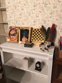 Painted bookcase displaying vintage "Cooper" Halloween items in original boxes; "Kodak" souvenir checker board set; child's vintage play Indian headdress, etc. 