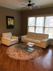 Natuzzi Italian leather sofa and chair.  Modern, glass coffee table and circular rug.