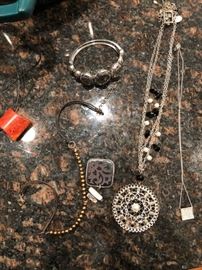 Large collection of costume jewelry including rings, earrings, necklaces and bracelets.