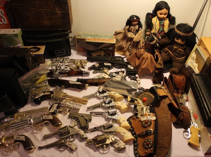Toy cap guns and Native American dolls