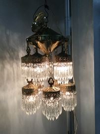 Two tiers of crystal prisms on this fantastic antique light fixture