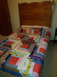 Handmade quilt; bed with amazing maple headboard.