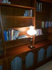 Wall shelf unit, antique lamp, lots of books