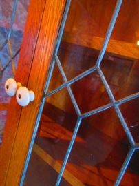 Detail of leaded glass doors on antique oak cabinet