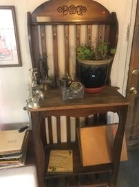  Baker’s rack on wheels in great condition. Painters case on the bottom. Most have Meat grinders !  Red geraniums with beautiful  ceramic  pot 
