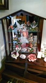 Lenox birds and other porcelain flowers in display case