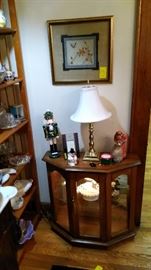 Display case with brass lamp