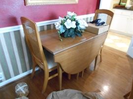 Drop-leaf table and woven chairs