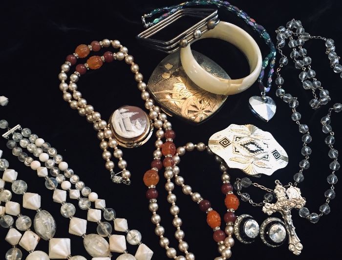 two tubs filled to the top with vintage jewelry