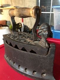 Antique clothing iron with head