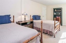 50's matching 4-poster twin beds and bookcase in the background