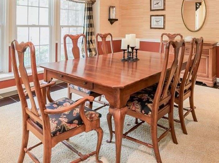 Graceful Queen Anne design dining room table with eight-chairs, two of which are captains chairs.