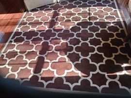 This geometric rug is 9.8' X 8' wide and can be found in the family room just off the kitchen