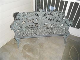 Wrought iron settee in the screened patio
