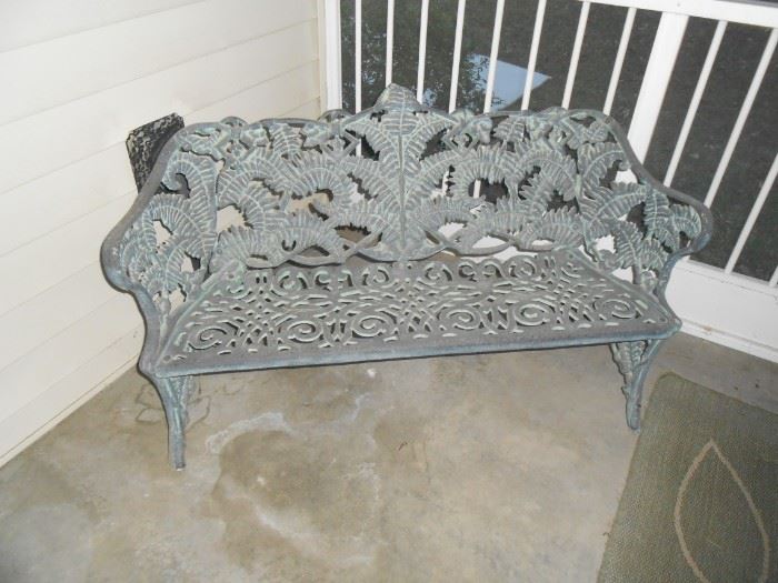 Wrought iron settee in the screened patio