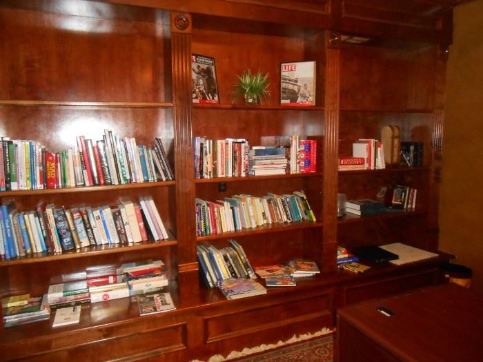 Numerous cookbooks and others in the front office just off the entrance foyer.
