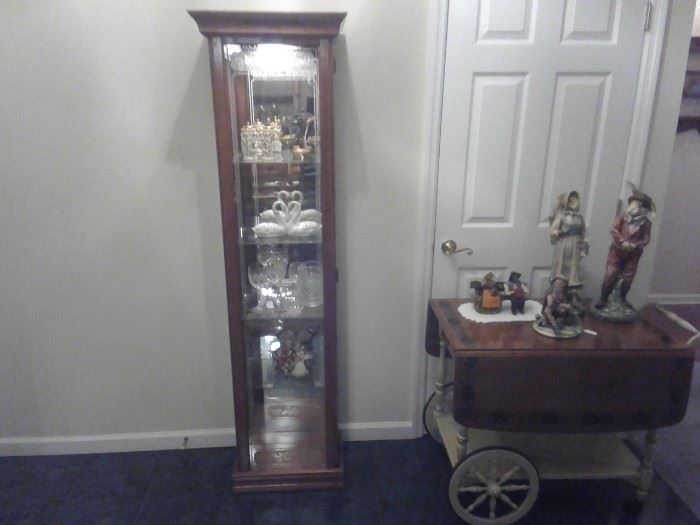 Lighted curio has Lladros and other pieces