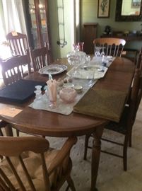 Maple dining table with 2 leaves. 4 oak chairs and 2 maple arm chairs. Several pieces of Fenton decorative glass.