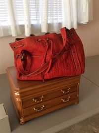 Red suede Caroline Herrera purse.