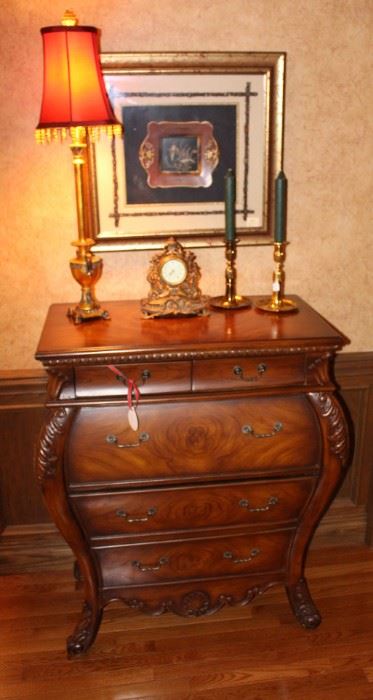 Beautiful chest of drawers, shown with lamp, candlesticks, clock and a framed tole tray.  
