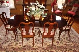 Dining room table has six chairs, two of the chairs have arms and two leafs. At $400.00 there is no excuse to go another holiday without dining room furniture! The rug is not for sale.