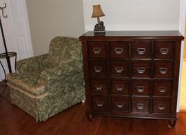 Chest of drawers shown with club chair.