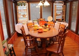 Breakfast nook has a very solid pedestal table with six chairs, Fiesta Ware, Pottery Barn dishes and lots more.