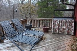 Two chaise lounge chairs and a dry sink/bar.