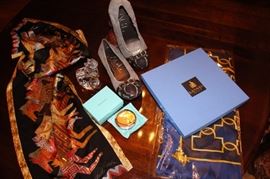 Just a sampling of our "goodie table" items. Lanvin Paris and Laurel Burch scarves, Tiffany compact, Waterford cat and Attilio Giusti Leombruni (AGL) shoes.
