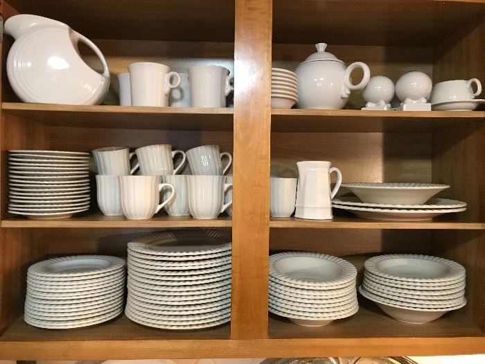 Set of white dishes including some "Fiesta" on the top shelf