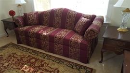 Living room sofa, rolled arms, camel back two mahogany end tables and Waterford lamps