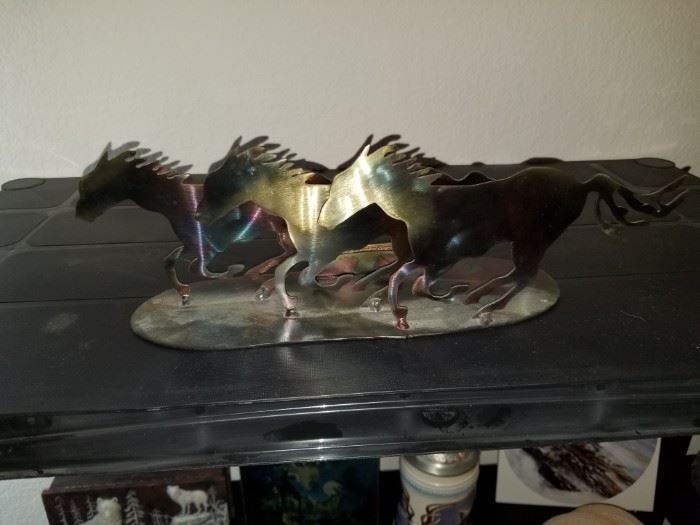 metal carved running horses