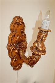 Orante carved electric sconce
