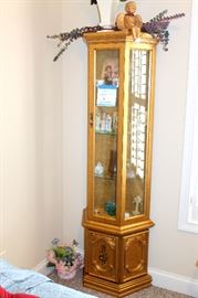 Lighted gold curio cabinet