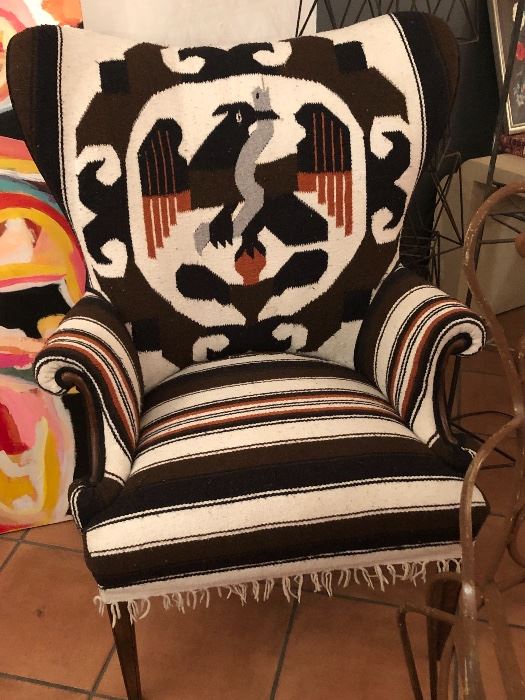 This custom chair reupholstered in a Peruvian textile. Complete with fringe, mid century legs. 