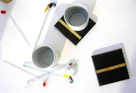 Accessories include handmade contemporary pieces such as porcelain cups and wood coasters.