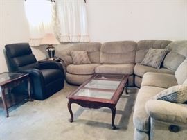Brown bonded leather LIFT recliner. Sectional has a WALL HUGGER recliner on one end and a swivel round chair on the other end.
