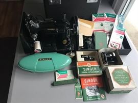 Numerous parts and accessories for Singer Featherweight sewing machine.
