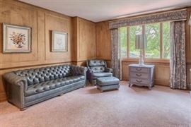 Deep powder blue Chesterfield sofa and matching chair with nail head trim